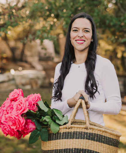 Dr. Alejandra Carrasco holding basket of flowers